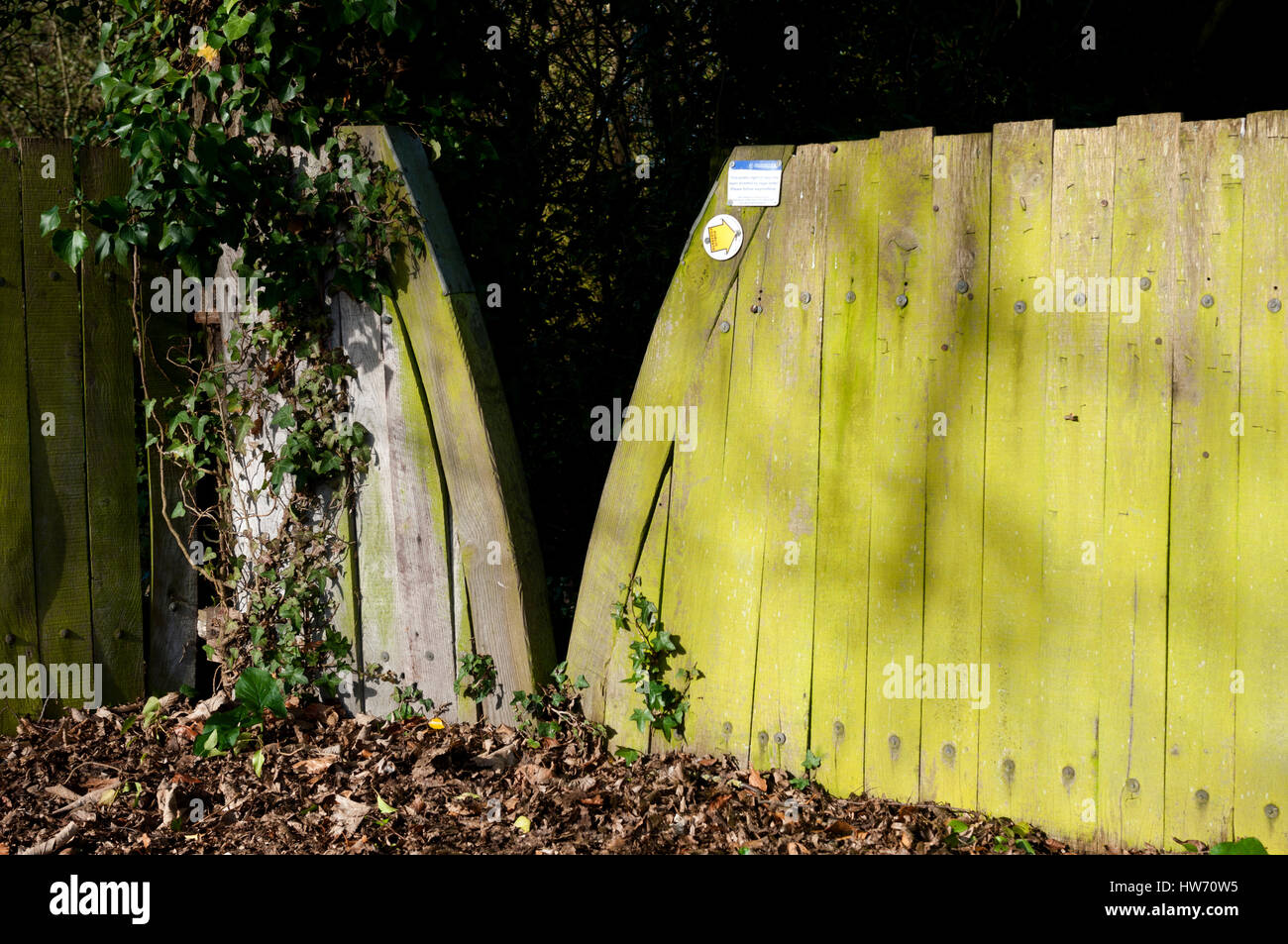 A wooden squeeze stile by St. Catherine`s churchyard, Staverton, Gloucestershire, England, UK Stock Photo